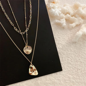 •	Beautiful set of three Multi Layered fun necklaces all in one package •	16” 18” and 20” set of three beautiful irregular shaped gold coins •	Fun to wear, trendy, and beautiful to look at •	Excellent quality •	Prepare for compliments!