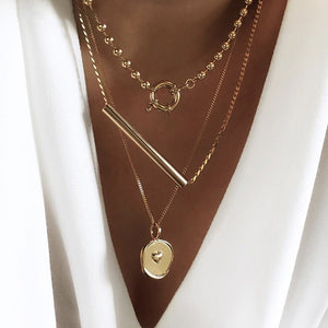 •	Beautiful set of three Multi Layered fun necklaces all in one package •	16” 18” and 20” set of three beautiful irregular shaped gold coin, long bar, and gold beads •	Fun to wear, trendy, and beautiful to look at •	Excellent quality •	Prepare for compliments!