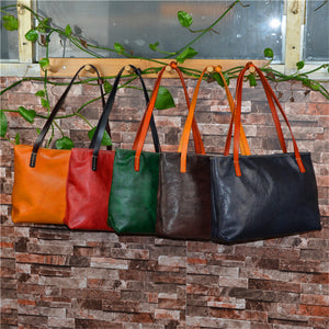 •	Elegant leather in five luxurious colors cut in the Shopper style •	14” L , 5” W , 11’ H  •	Thick, durable, superb quality cow leather •	Five beautiful colors: Black, Coffee, Red, Yellow, Green •	This bag will last for many years… Prepare for compliments!